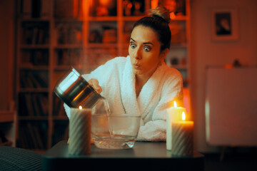 Woman Pouring Hot Water for at Home Steam inhalation Treatment. Puzzled girl trying an alternative relief for her congested nose 
