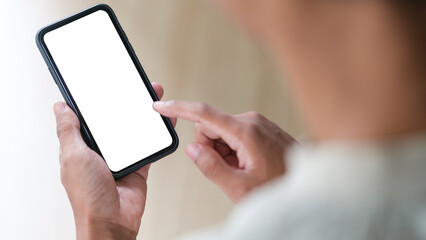 View over shoulder of man hands holding smart phone. Empty screen for your advertise text.