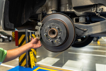 Close up view of a Maintenance Car service - auto oil change, motor check, brake cleaning, tire check, engine inspection, motor oil-brake inspection