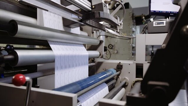 Industrial printer applies pattern on paper in typography