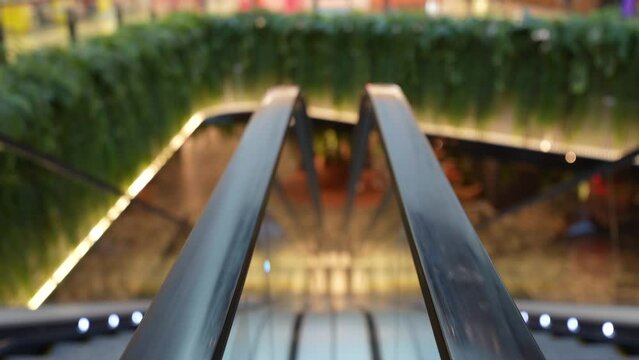 Escalator in a shopping mall in Canberra, Australia. Fast moving people on escalator. Modern shopping mall urban architecture concept