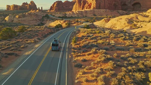 Paved Road Of The Scenic Arches Drive During Sunset In Utah, United States. Aerial Shot