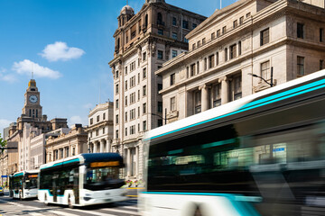 financial buildings in the Bund of Shanghai and moving bus on the highway