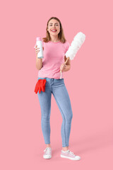 Young woman with air freshener and pp-duster on pink background