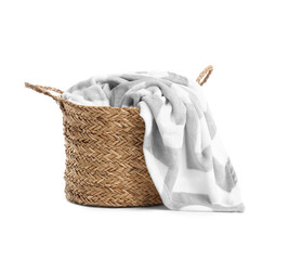 Wicker basket with blanket isolated on white background