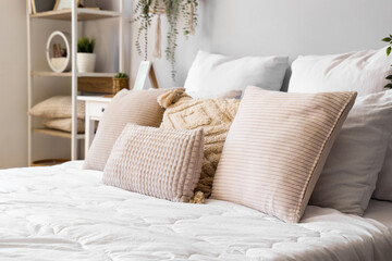 Fototapeta na wymiar Cozy bed with soft pillows, closeup