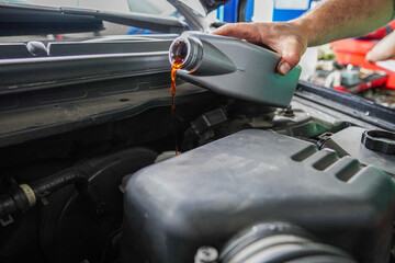 Close up view of a Maintenance Car service - auto oil change, motor check, brake cleaning, tire...