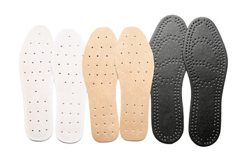 Set of different orthopedic insoles on white background