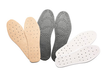Set of different orthopedic insoles on white background
