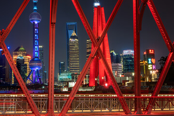 a famous bridge of The Bund in Shanghai at night and beautiful light trail at highway