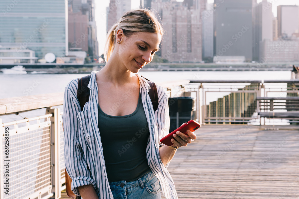 Poster positive caucasian tourist checking notification for gps application on cellphone device