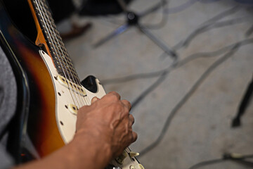 hand of male musician playing electric guitar close-up photo