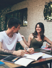 Young happy people studying together in terrace