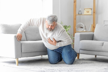 Elderly man having heart attack at home