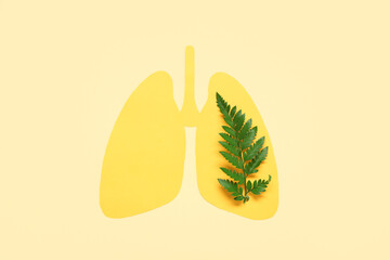 Paper lungs with green leaves on beige background. Lung cancer concept