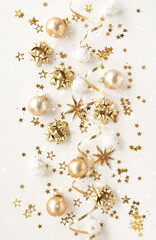 Obraz na płótnie Canvas Christmas background with Xmas golden decor pattern top view on white backdrop .Beautiful Xmas greeting card. Poster.New Year decoration.