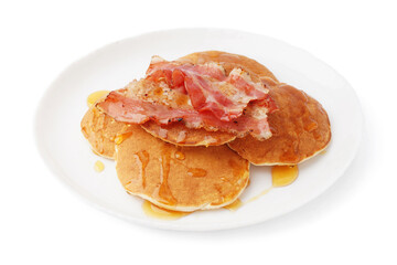 Plate of tasty pancakes with bacon and maple syrup on white background