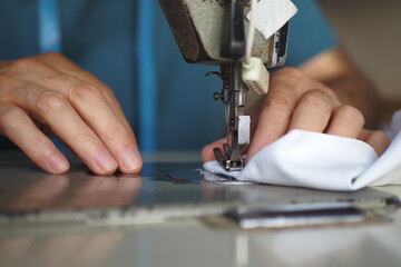 men hands using a sewing machine .