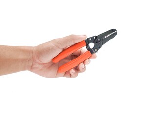 Male hand holding wire stripping pliers with orange handles isolated on white background.