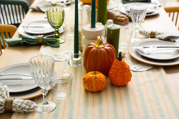 Festive table setting with pumpkins for Halloween party, closeup