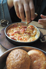 Turkish Menemen omelet in a frying pan. .