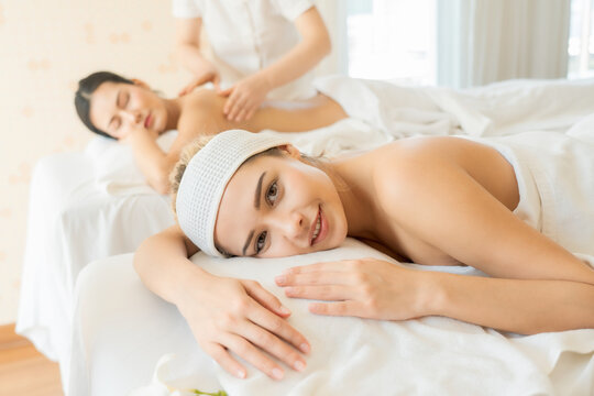Spa and massage concept, Two young beautiful women enjoying a massage on table in spa salon.