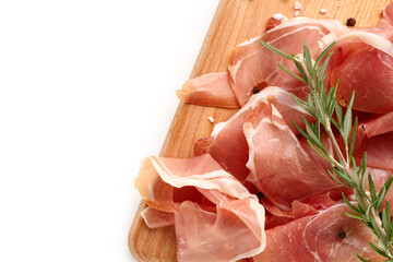 Wooden board with slices of tasty prosciutto and rosemary on white background