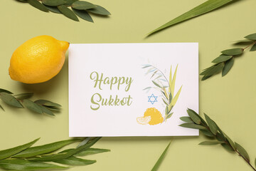 Four species (lulav, hadas, arava, etrog) and greeting card with text HAPPY SUKKOT on green...