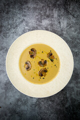 mushroom soup puree with champignons in a white plate top view