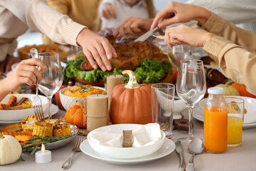 Happy family having dinner at festive table on Thanksgiving Day, closeup