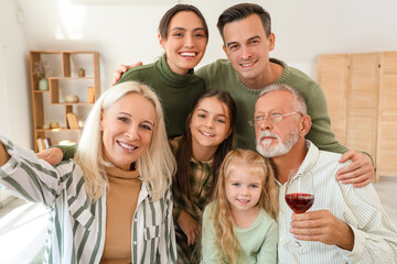 Happy family taking selfie at home on Thanksgiving Day