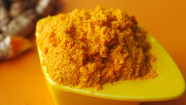  turmeric root and paste in a bowl on white background 