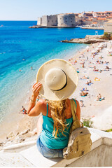 Fototapeta na wymiar Woman tourist enjoying view of Dubrovnik city and beach- Travel, tour tourism in Croatia