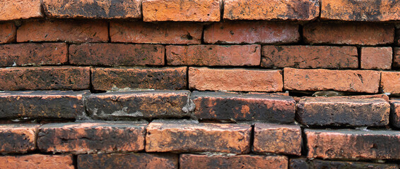 Old brick wall background, brick wall texture, structure. old broken brick, cement joints, close-up.