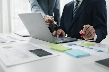 Finance and Marketing Business Meeting, Two businessmen are meeting together and looking at financial and marketing documents to plan how to grow their business. Business meeting concept.