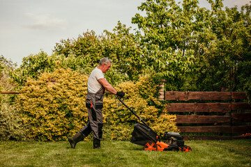 A senior man in a smart suit trims the hedges in his garden, demonstrating that a lifelong love for...