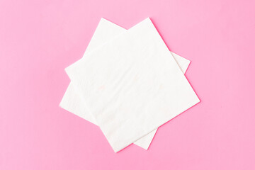 Paper napkins on pink background close up