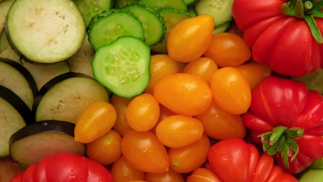 Mixed fresh vegetable background. Healthy eating ingredients. Slice of mix veggies, tomatoes, cucumbers, cherry tomato, eggplant. Nutrition, diet, vegan food. Assorted fruits rotating view closeup 4K	