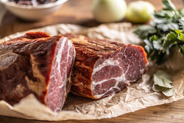 Smoked pork neck cut into two parts ready for heat treatment