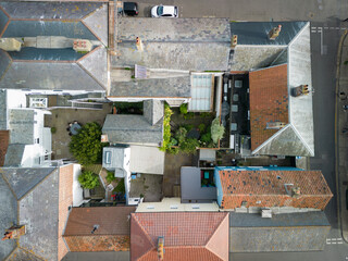 Fototapeta na wymiar Drone top down view of a garden courtyard nestled between old English houses. Located at a popular Suffolk, UK coastal town.
