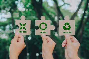 Hand holding Jigsaw with reduce, reuse, recycle symbol. Ecological and save the earth...
