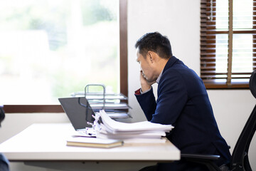 Asian man stressed while working, Sad, unhappy, Worried, Depression, or employee life stress concept