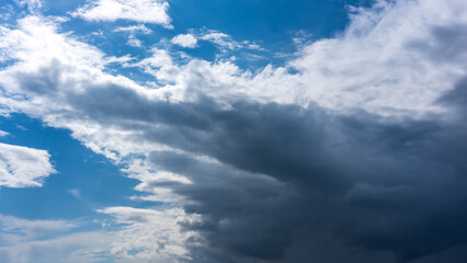 Naklejka na ściany i meble Upcoming storm clouds on a sunny day
