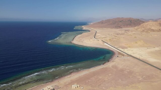 Beautiful landscape with dunes near Red Sea on sunny day, Tabuk. Aerial
