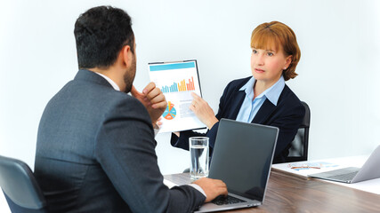 Obraz premium Business woman showing document to business man, professionals discussing papers working in office at meeting.