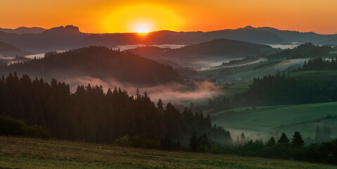 Beautiful sunrise in the picturesque mountains. Picturesque mists rolling in the valleys illuminated by the rays of the rising sun,Pieniny,Poland