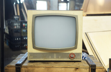 An old TV sits on a box. Retro technology concept. 