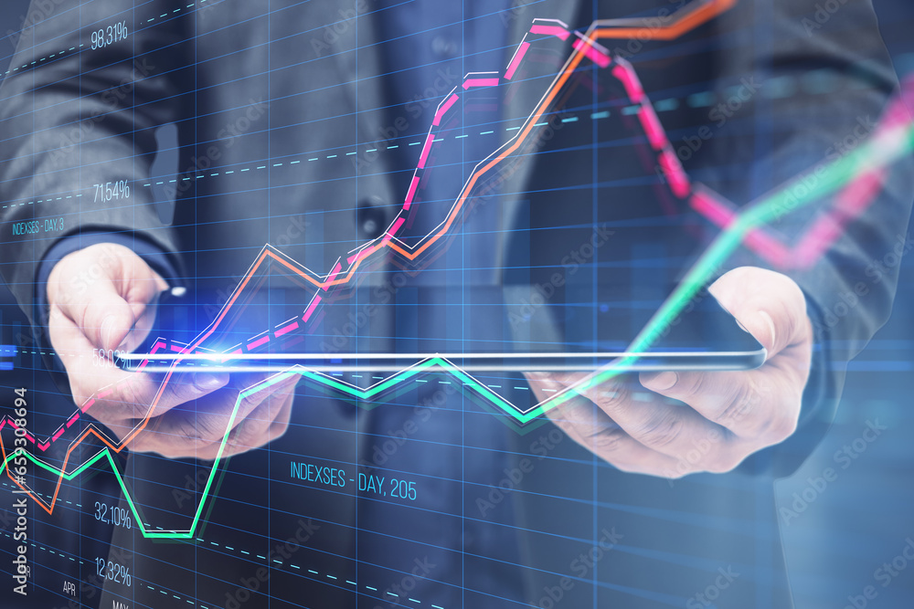 Poster close up of businessman hand holding tablet with creative business graph with index and grid on blur