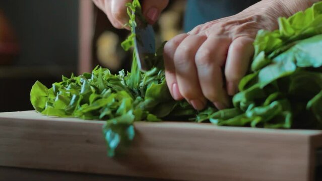 Chard leaves are chopped on the cutting board