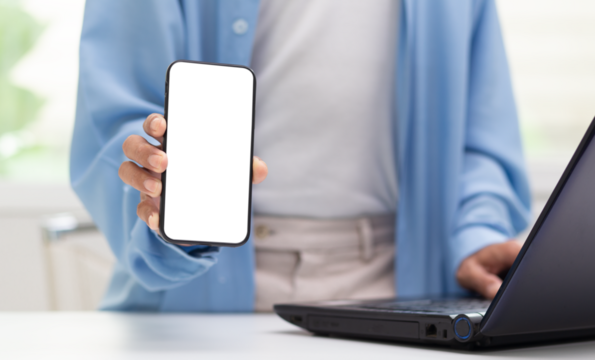 person holding smartphone with transparent screen and laptop on table, web design graphic application on smartphone concept, PNG file